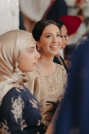 Wedding guests in traditional attire share a joyful moment during celebration.