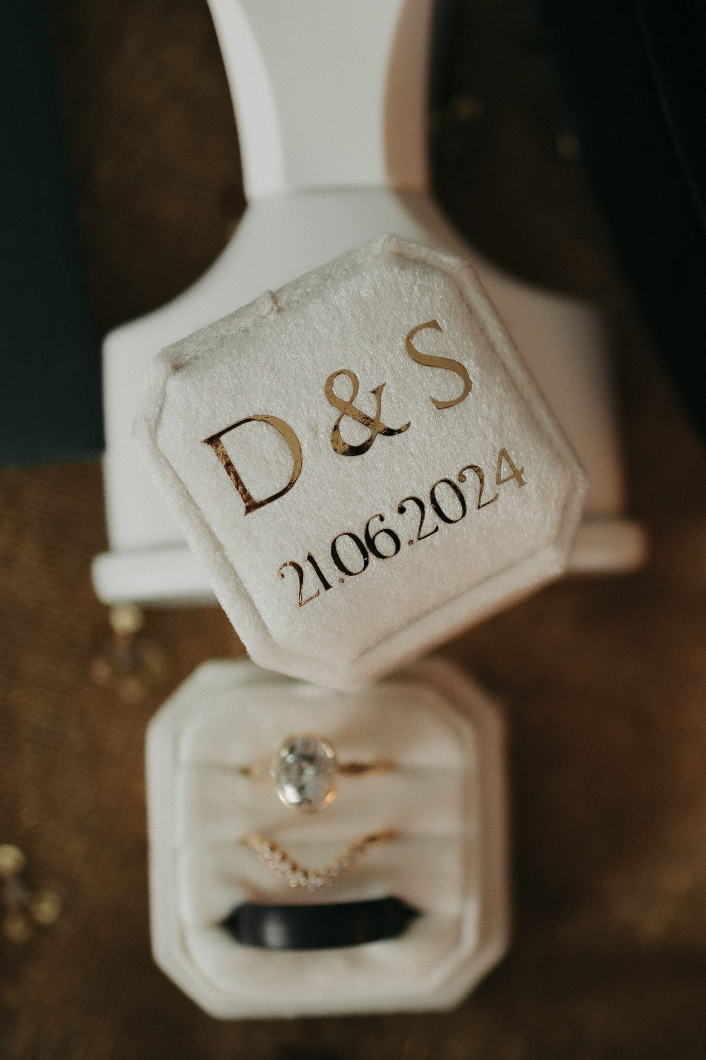 Engagement ring in white box with engraved date 'D&S 21.06.2024'.