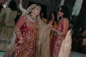 Traditional South Asian wedding celebration with guests in ornate formal attire.