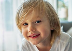 Close-up portrait in natural window light showing pure joy.
