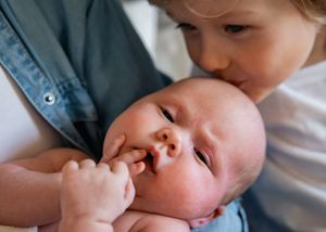A tender moment of bonding between a family with a newborn baby in their arms.