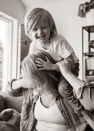 Candid black and white capture of joyful playtime at home.