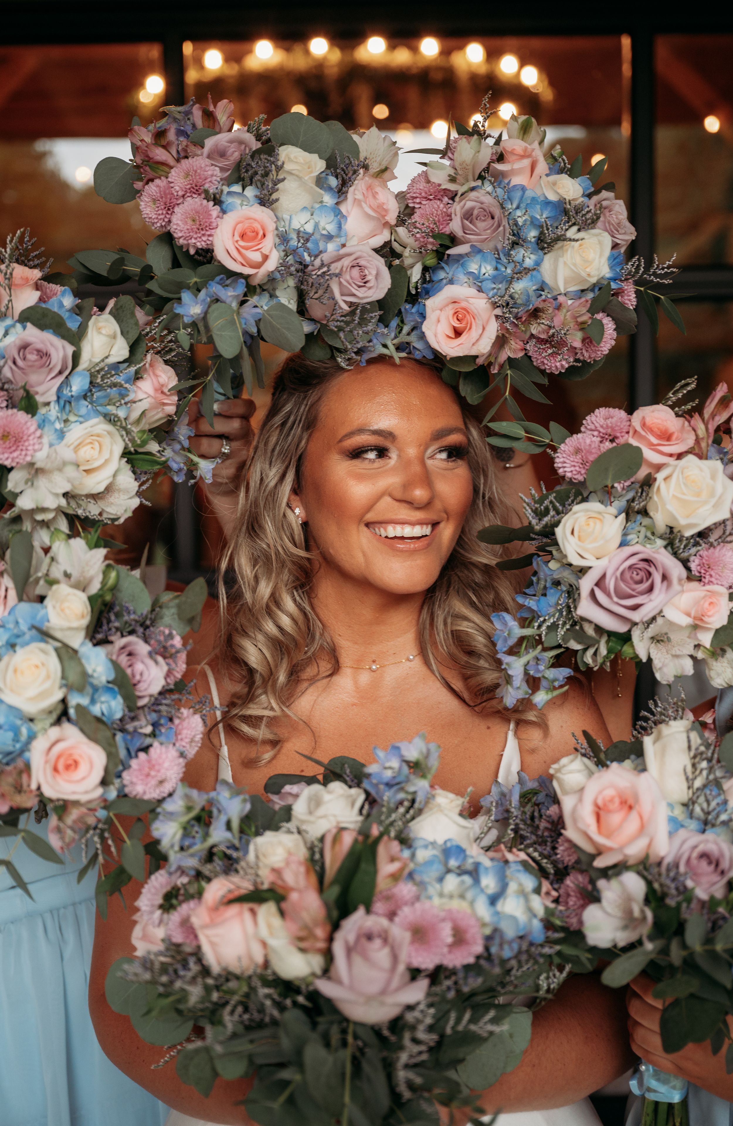 Beautiful wedding bouquets featuring pink and blue roses with delicate floral arrangements.