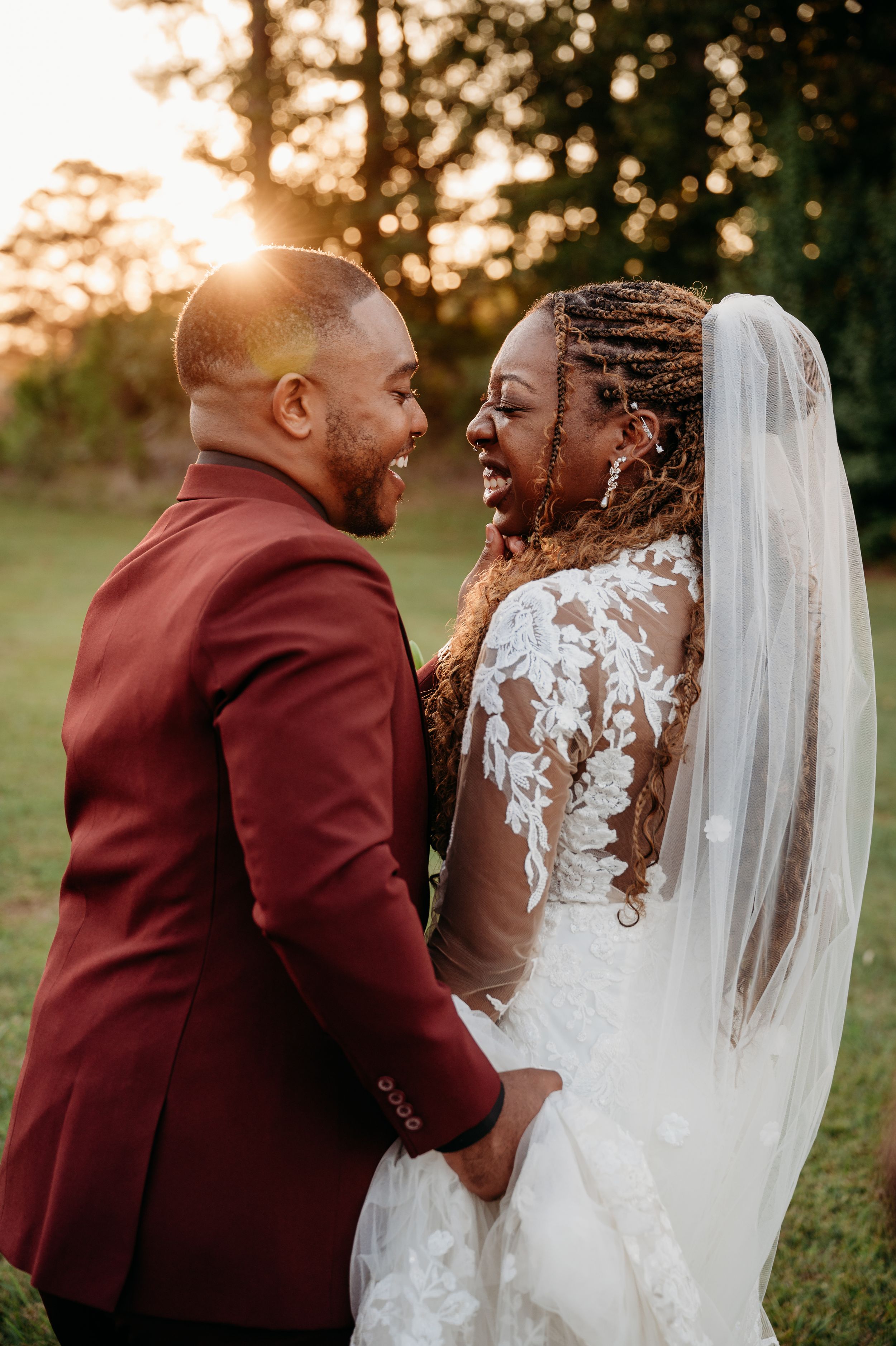 A candid wedding moment captured during golden hour in a natural outdoor setting.
