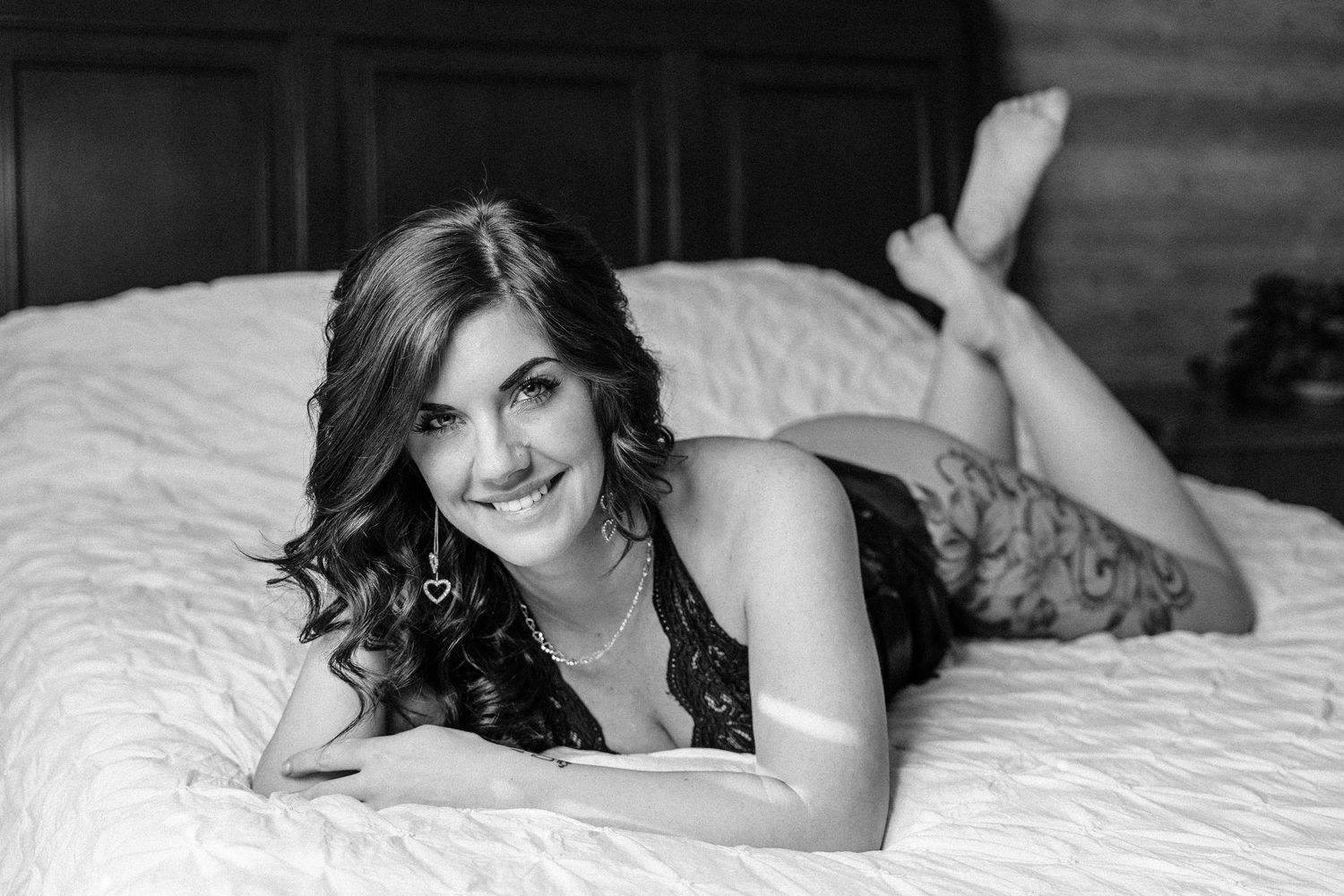 Photo of a woman laying on a bed for a birthday boudoir photo session taken by East Tennessee boudoir photographer in Dandridge studio