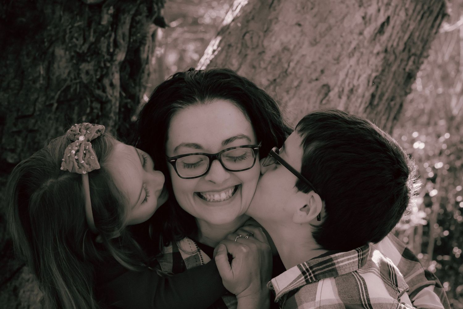 A moment of love and adoration as a mum receives a kiss on the cheeks from both of her children