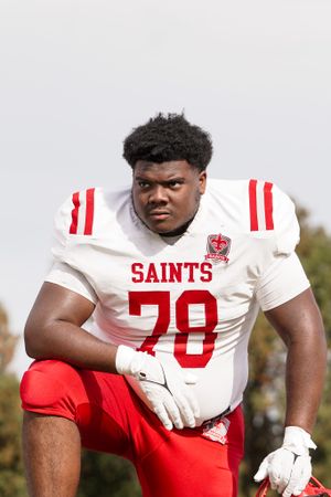 Saints football player in white uniform number 70 poses for portrait.