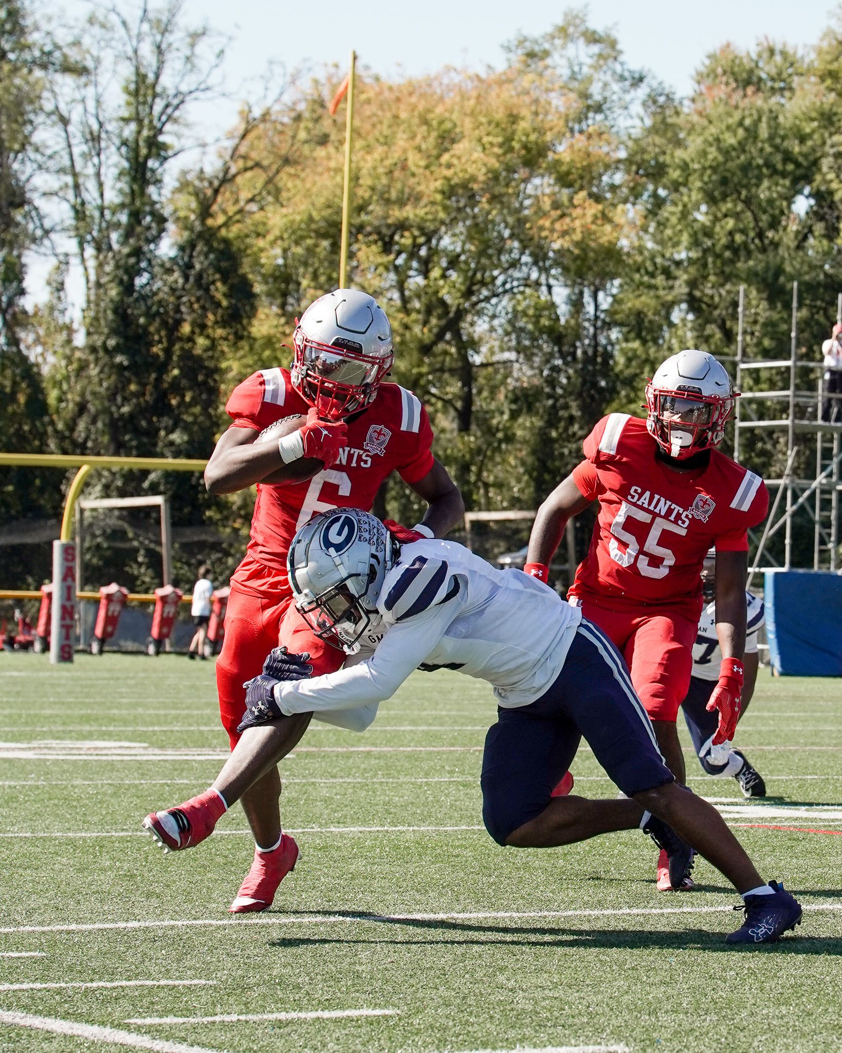 Football action shot showing tackle attempt during competitive game.