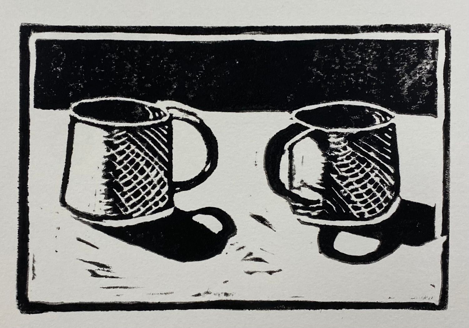 Simple woodblock print showing two coffee mugs with cross-hatched shading.