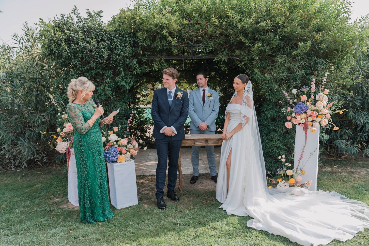 Outdoor wedding ceremony setup with a rustic wooden altar decorated with floral arrangements.