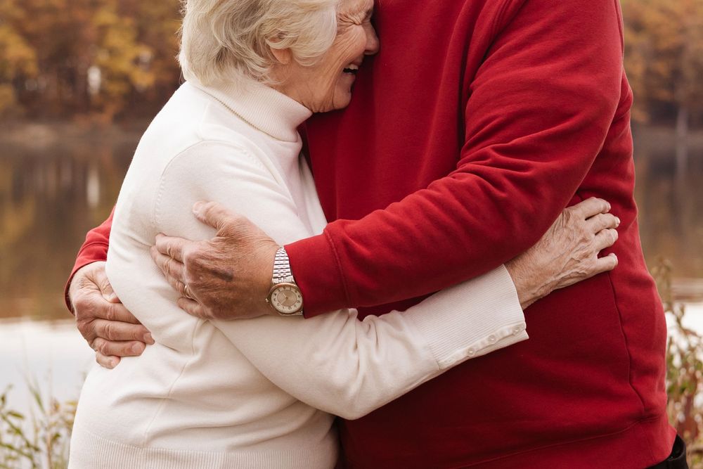 Close-up shots of family members embracing in red and white sweaters.