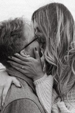 An intimate black and white portrait of a couple sharing a romantic moment.