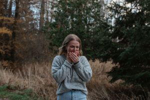 An emotional reaction captured during a surprise moment in a natural outdoor setting.