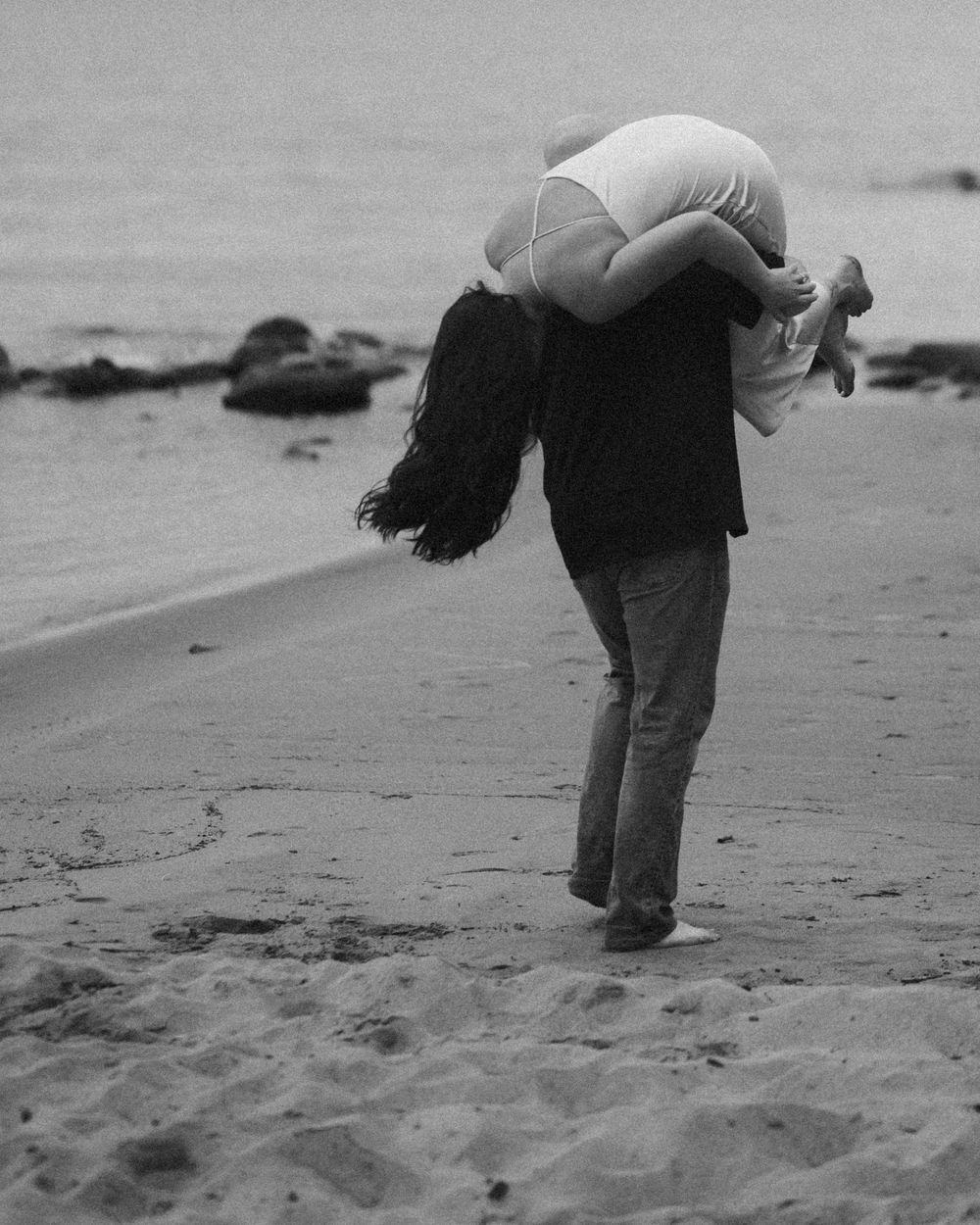 Black and white photo sequence showing footprints being made in beach sand.