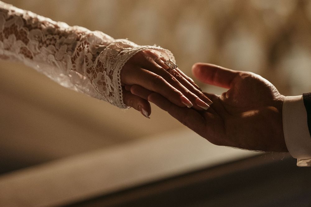 Close-up detail of hands in warm lighting.