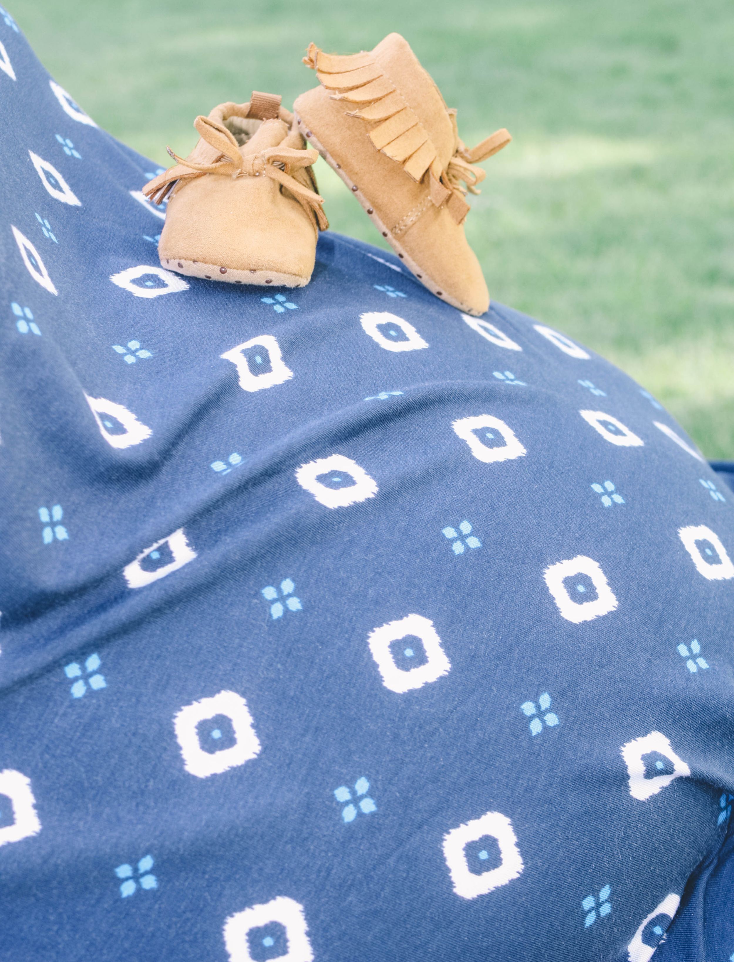 Blue patterned fabric with geometric designs and tan moccasin shoes.