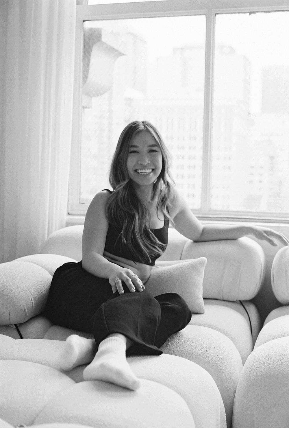 Black and white portraits showing relaxed poses on a comfortable white couch.