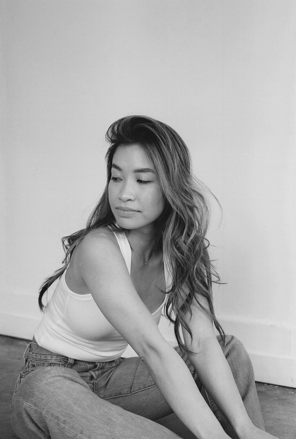 Artistic black and white portraits capturing graceful poses in casual attire.
