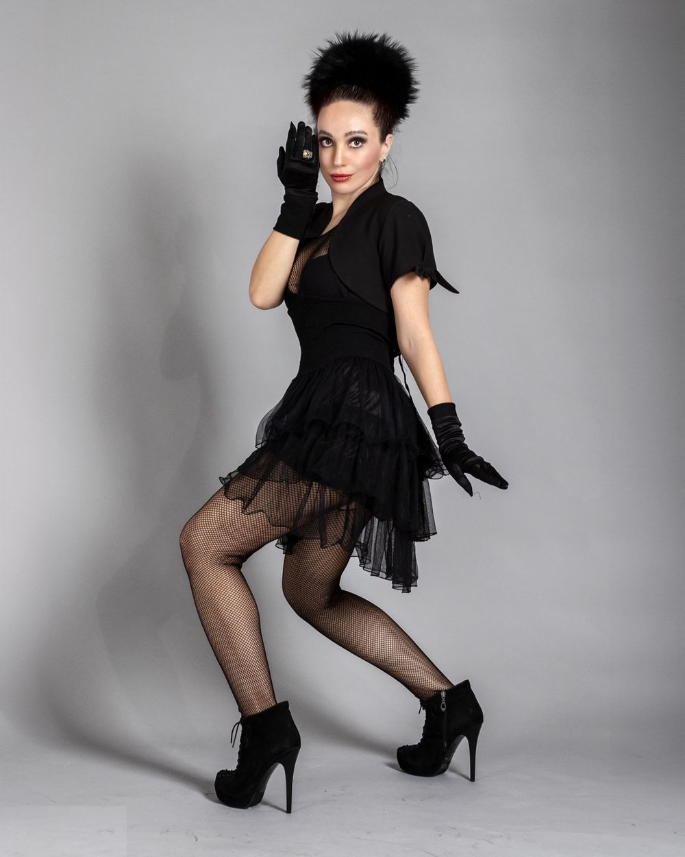 Retro-inspired black tulle dress with matching gloves and dramatic spiky hairstyle.