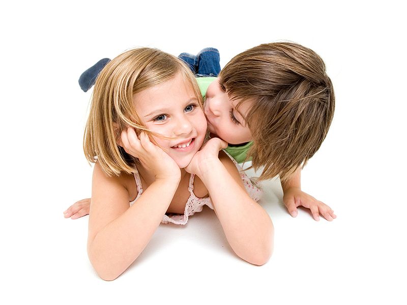 A family portrait featuring two children resting on the floor with their heads touching, taken by Abigail's Studio, Buckinghamshire.