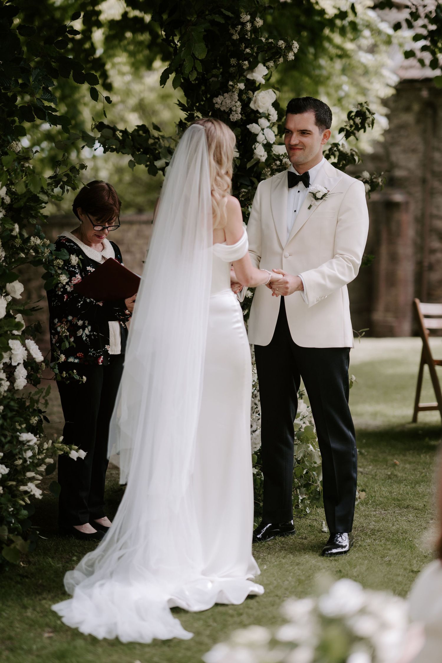 bride and groom holding hands and smiling during ceremony at Hamswell house in bath