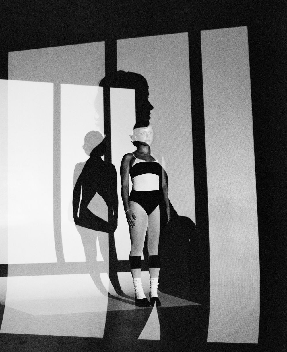 Minimalist fashion photograph with strong geometric shapes and shadows.