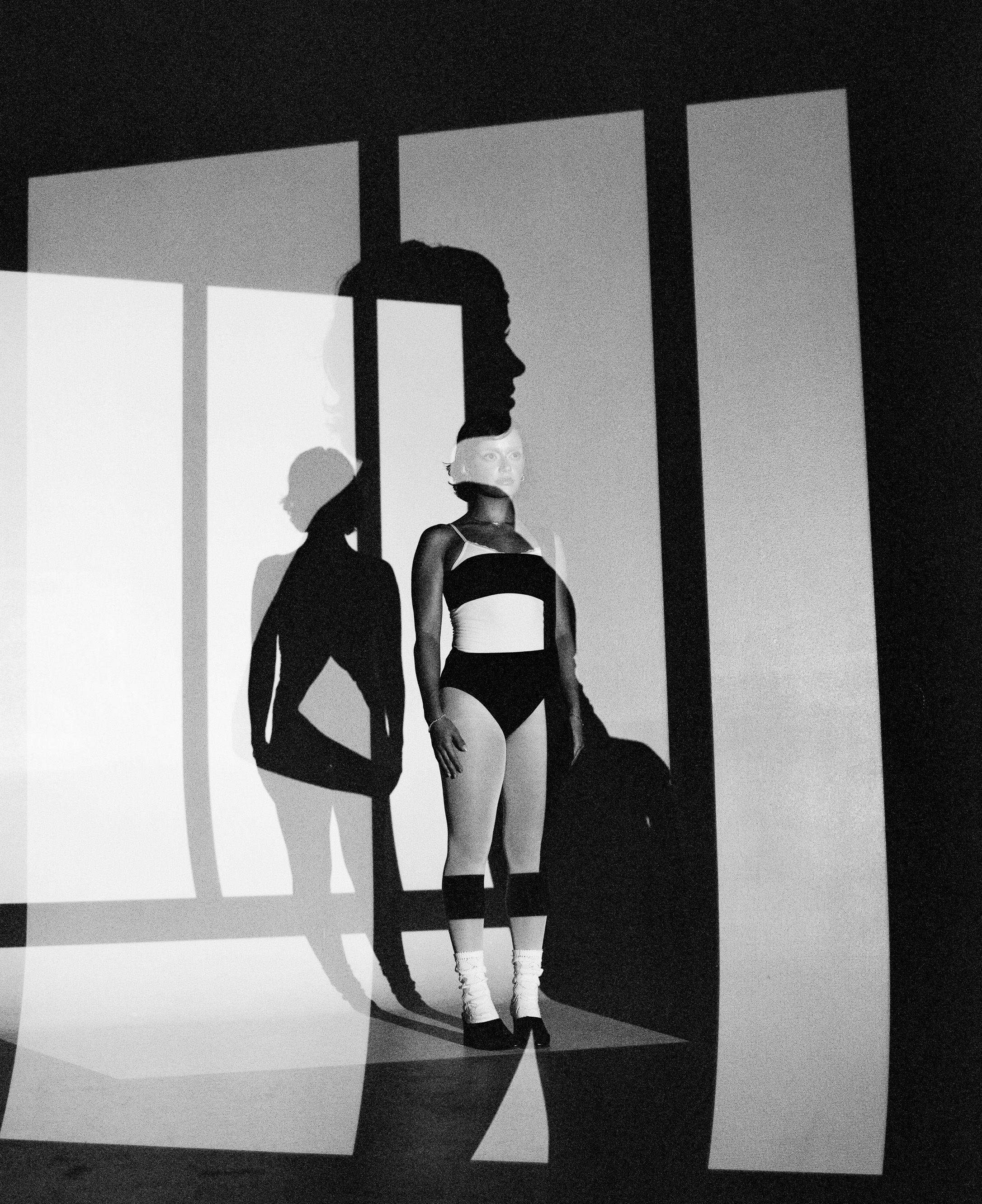 Minimalist fashion photograph with strong geometric shapes and shadows.
