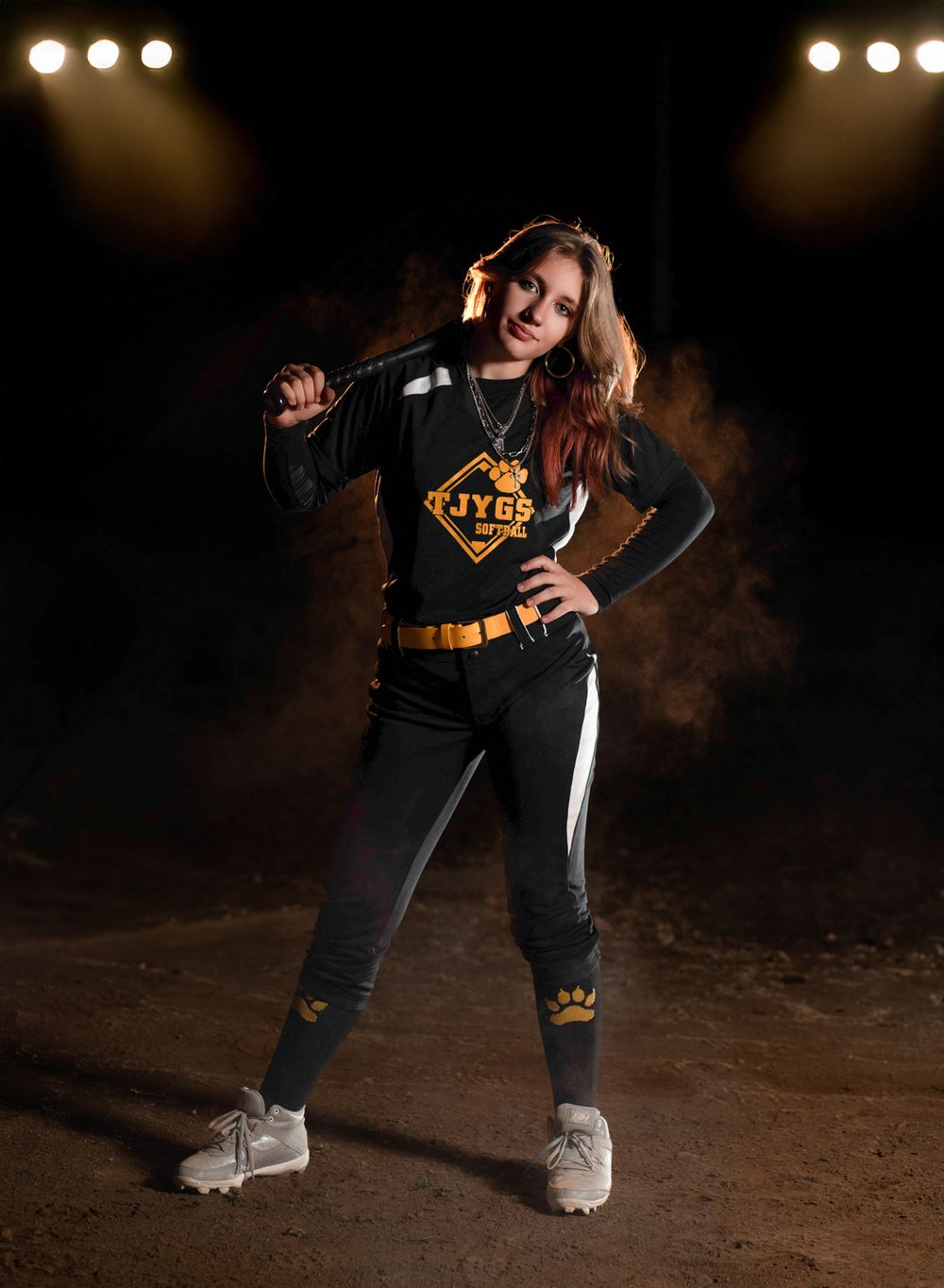 Athletic figure in black and yellow sports attire poses dramatically against dark background with spotlights.
Pittsburgh Sports Photographer