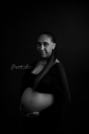 Black and white artistic maternity photography showing silhouettes and dramatic lighting in a series of intimate shots.