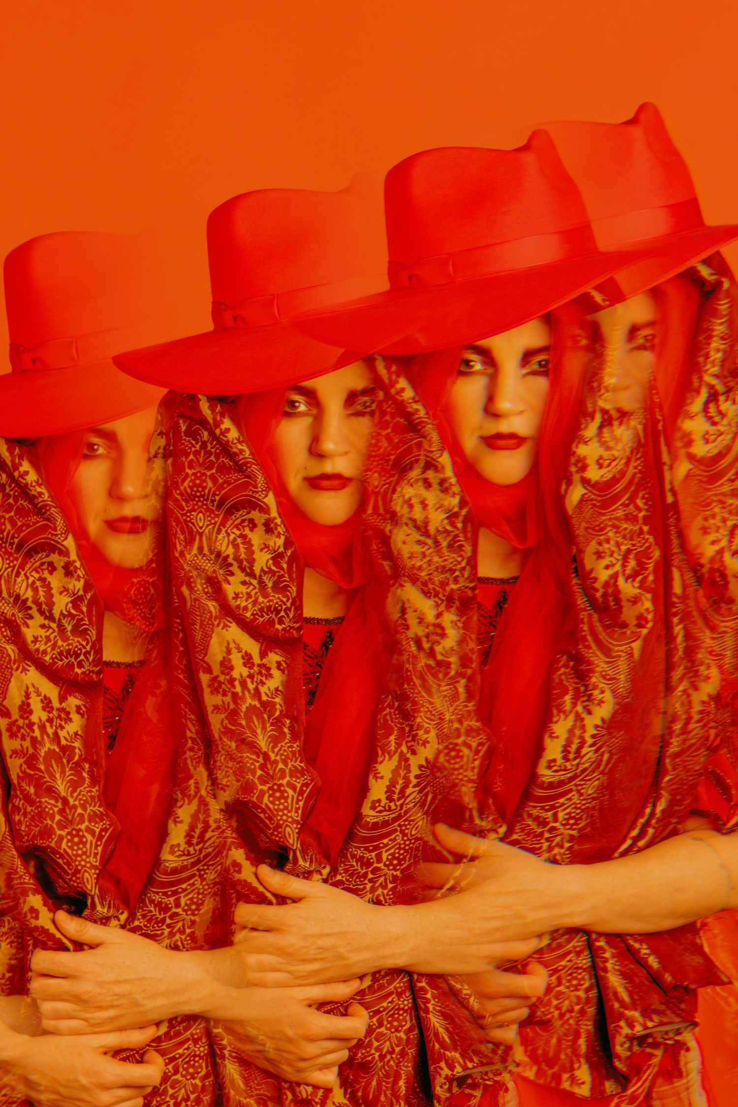 Multiple overlapping figures in red hats and patterned clothing create an artistic composition.