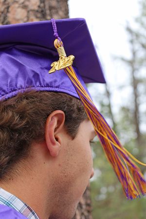 Close-up of purple 2022 graduation cap with gold and purple tassel worn by graduating senior.