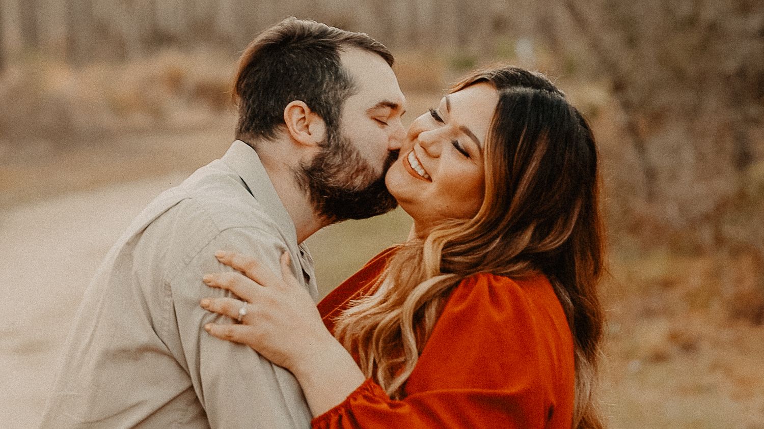 couple dancing in golden hour light during engagement video shoot