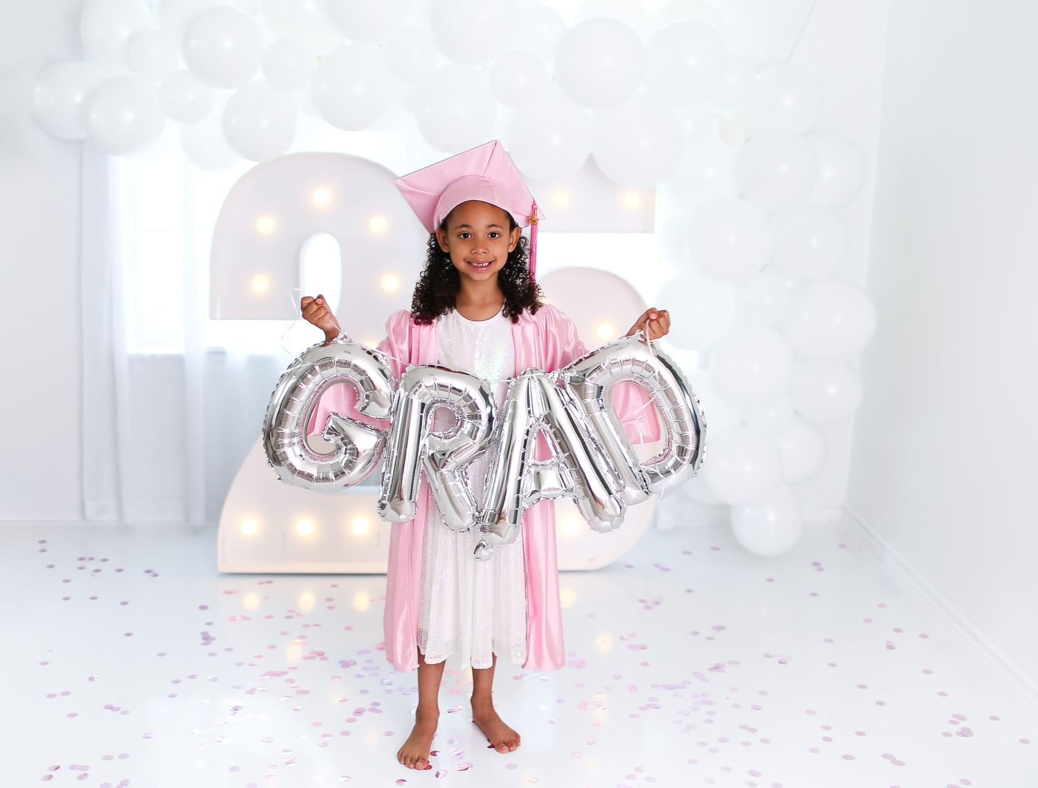 Kinder graduate had ballon reading GRAD