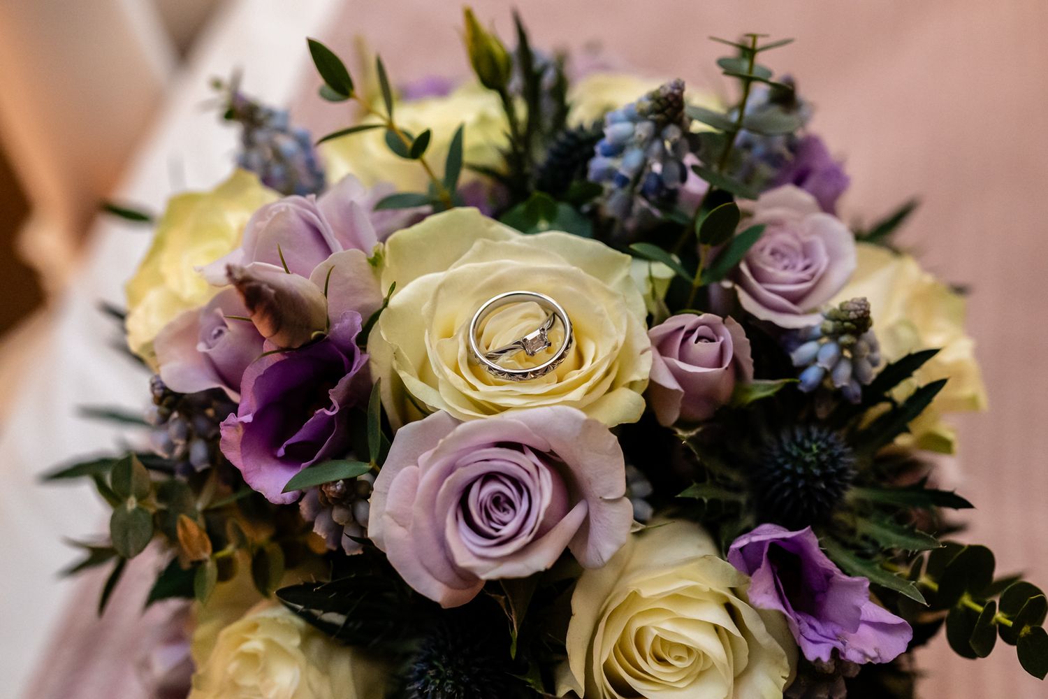 wedding rings on bouquet of roses