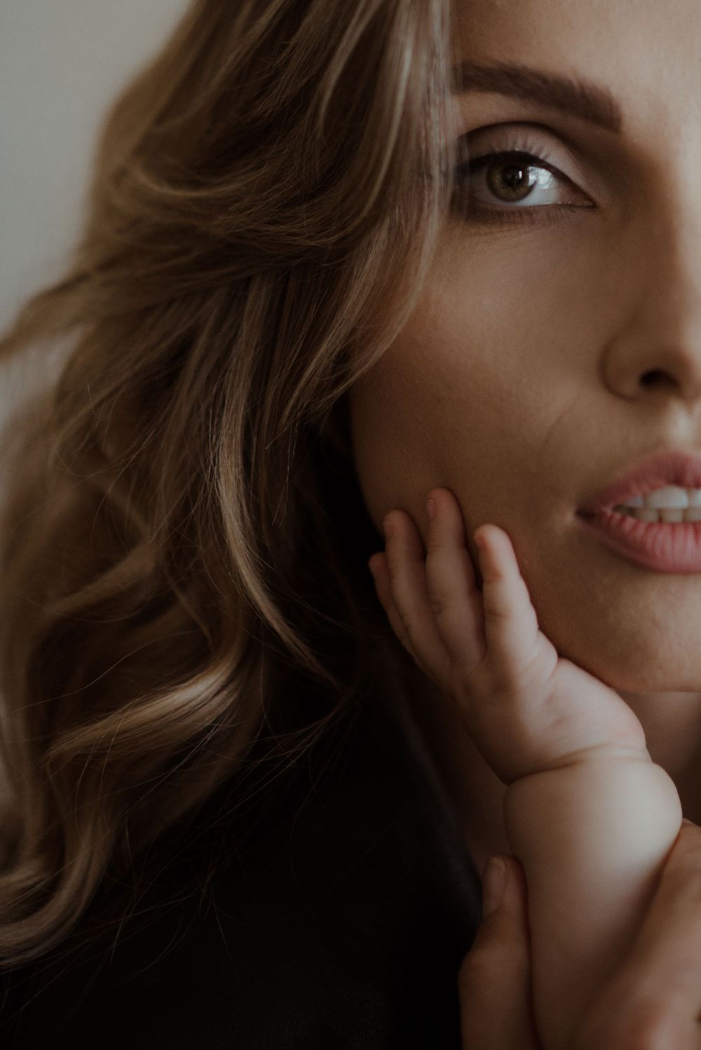 Moody close-up portraits in warm tones focusing on facial features with dramatic shadows.
