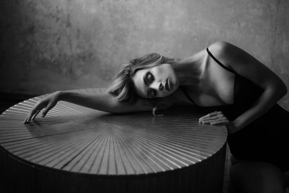 A set of dramatic black and white artistic portraits showcasing ethereal poses with paper fans.