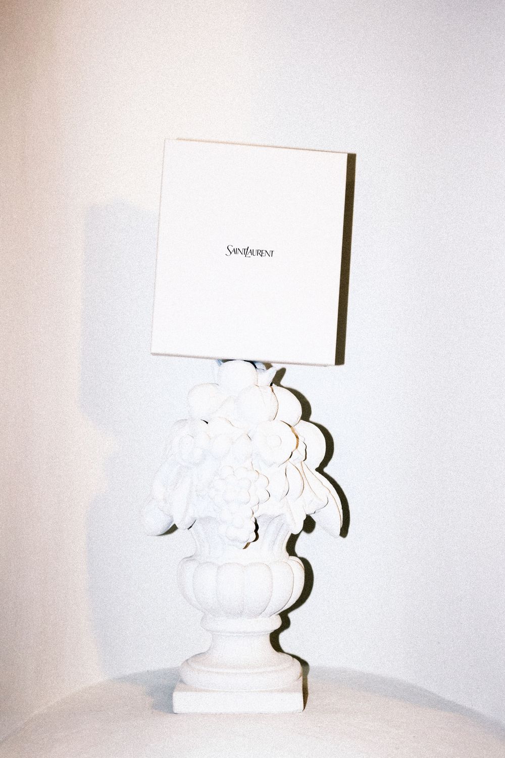 A series of white ceramic figurine place card holders arranged in a progressive sequence against a white background.