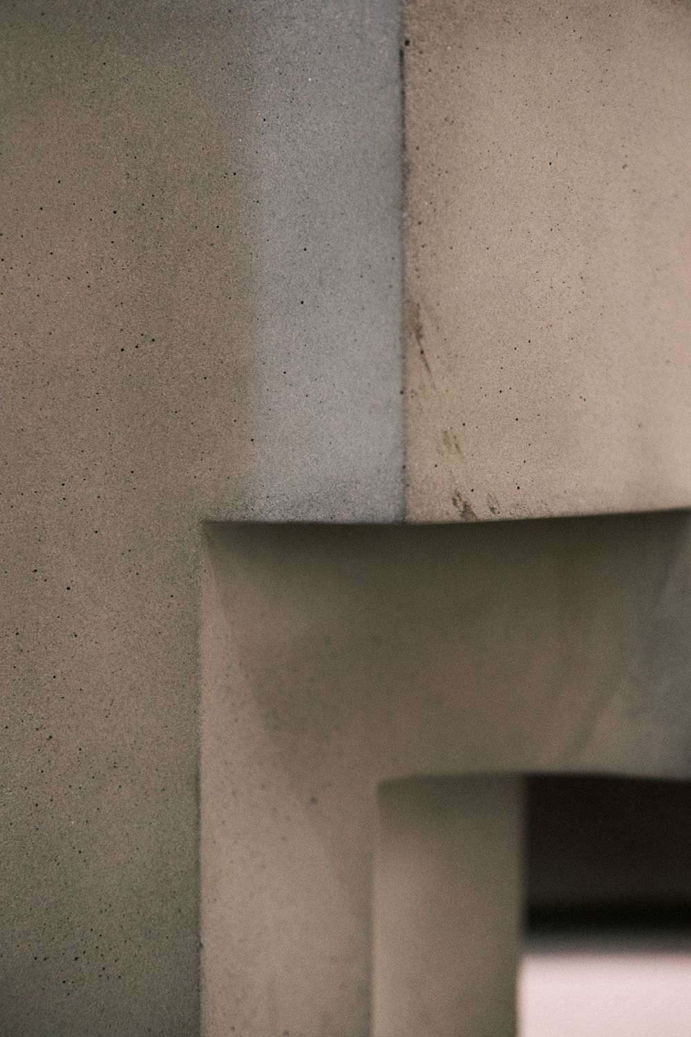 Architectural branding photo of textured stone walls and abstract lines, emphasizing design-focused brand storytelling.