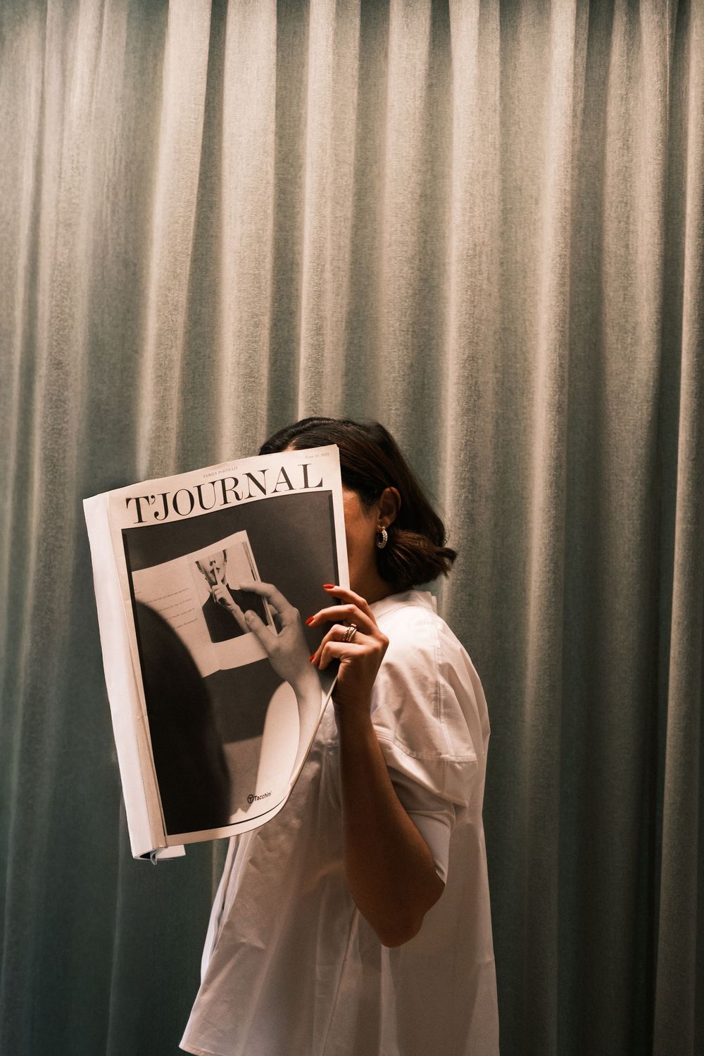 Series of silhouettes holding paper signs against a curtained backdrop.