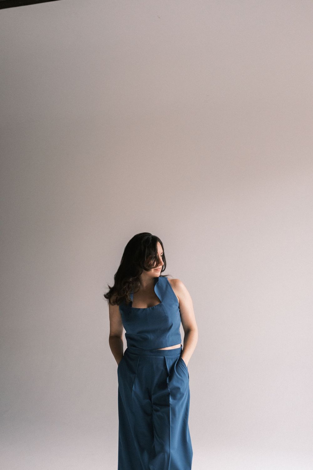 Fashion series showing movement in a blue dress against white background.