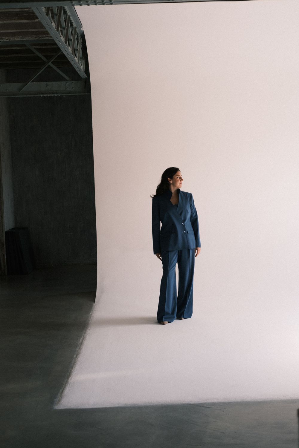 Minimalist fashion photography series featuring a blue dress in white studio space.