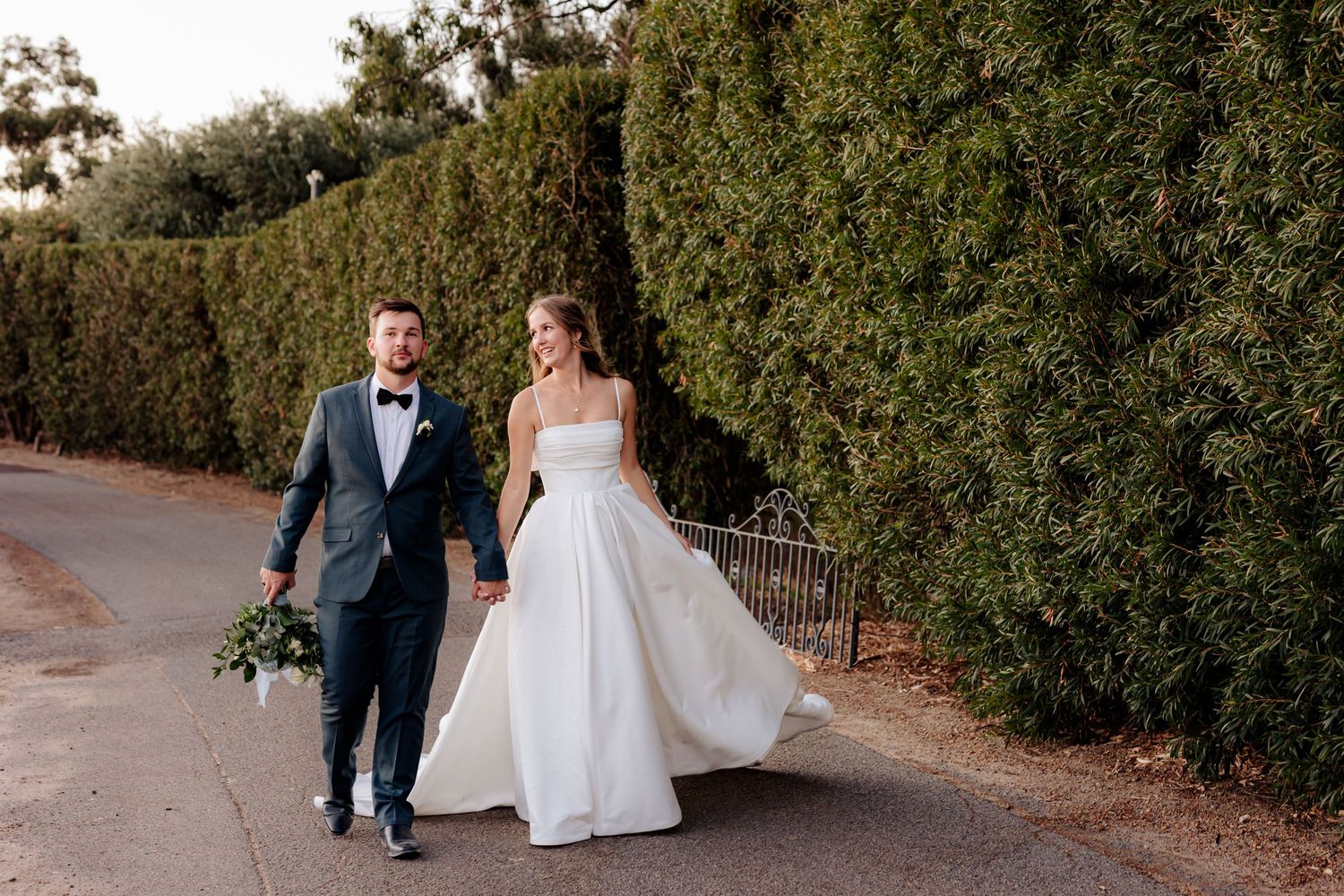 Wedding couple shares a laugh during their outdoor ceremony.
