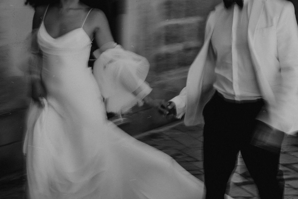 Motion-blurred dance sequence showing romantic movement on a dark dance floor.