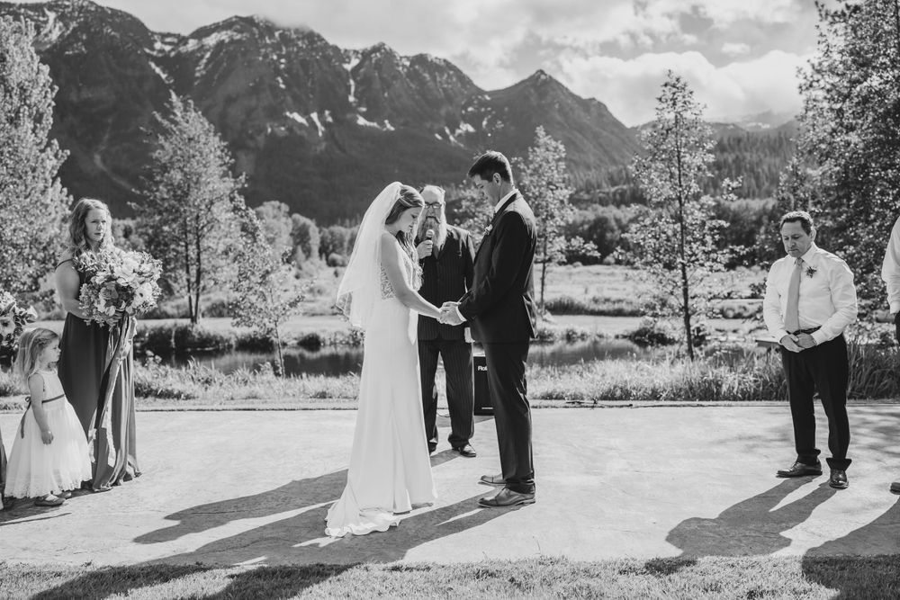 Outdoor mountain wedding ceremony with dramatic peaks in the background.