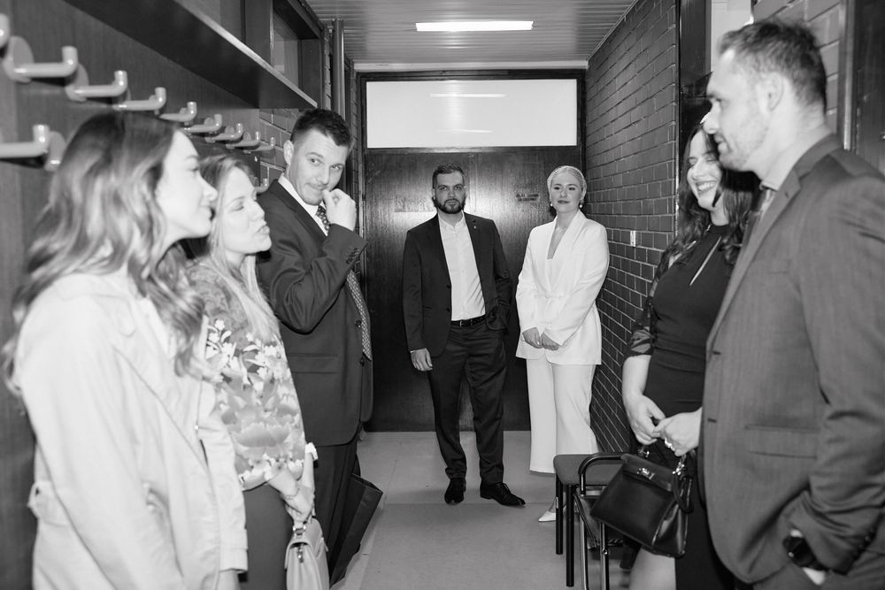 Black and white collage of candid moments from what appears to be a formal event or gathering showing multiple group interactions.