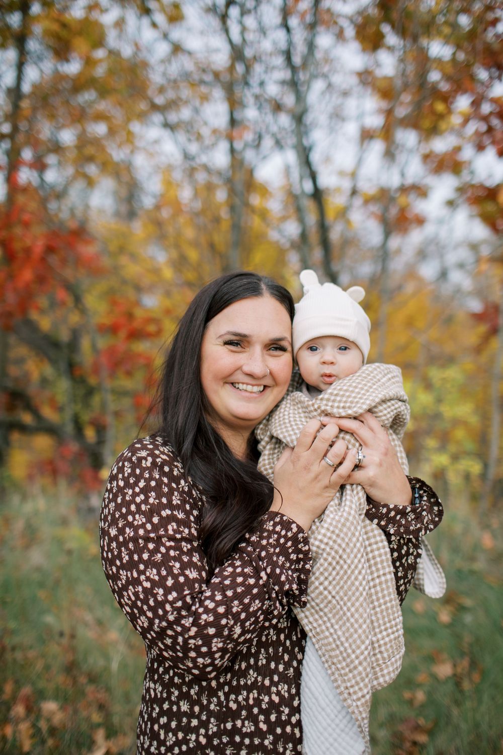 Three candid outdoor portraits showing loving interaction between parent and child against colorful autumn foliage.