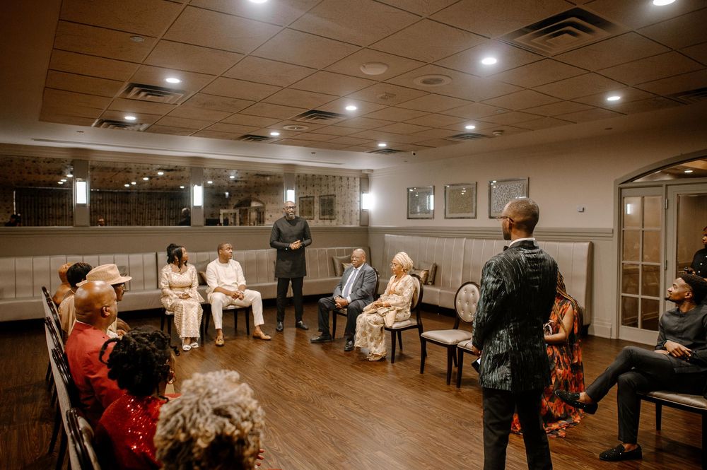 A group of seniors practicing dance moves in a large mirrored studio with wood floors and recessed lighting.