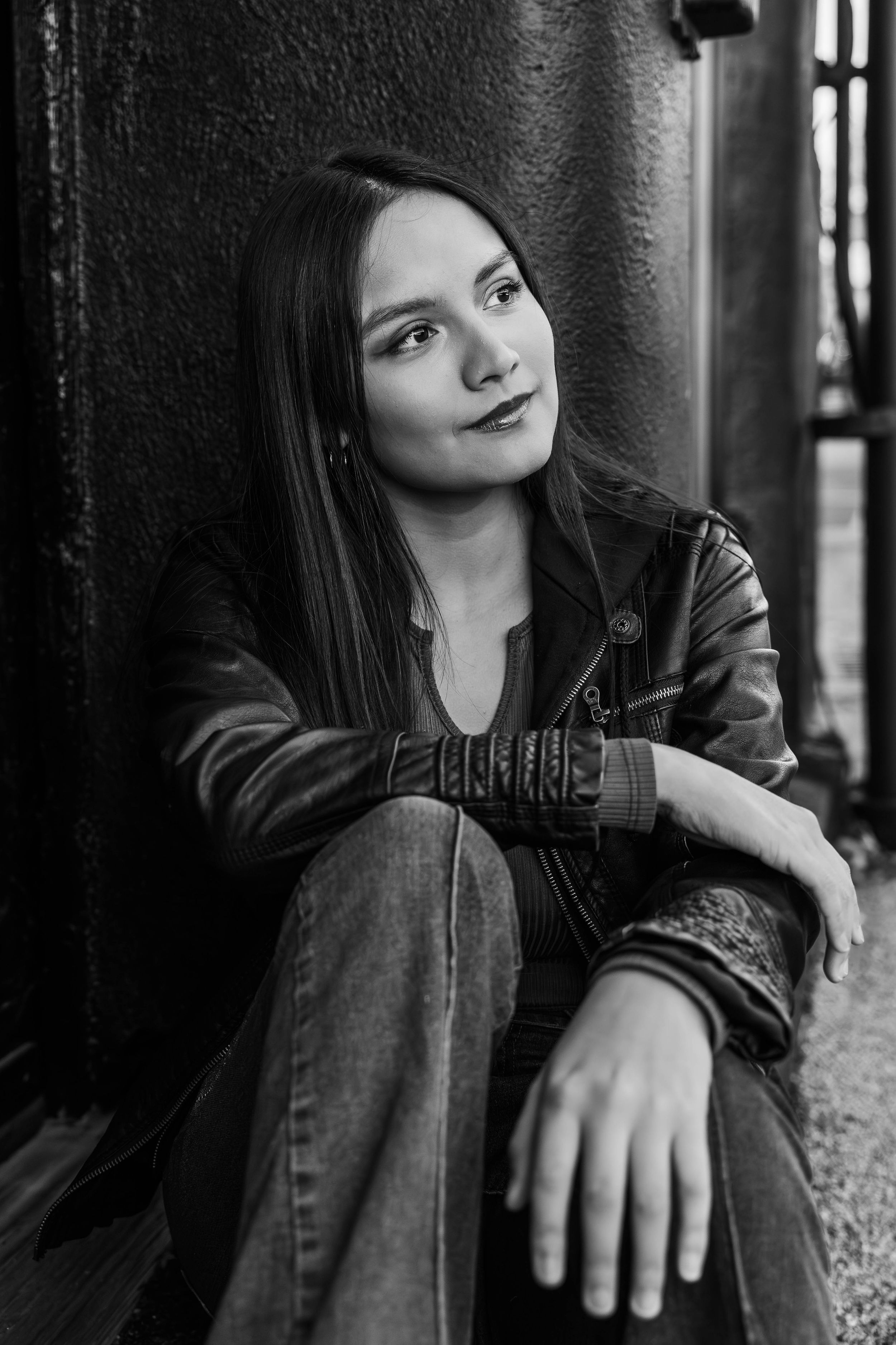 Moody black and white portrait series showing a person in denim jacket against dark background in different poses.