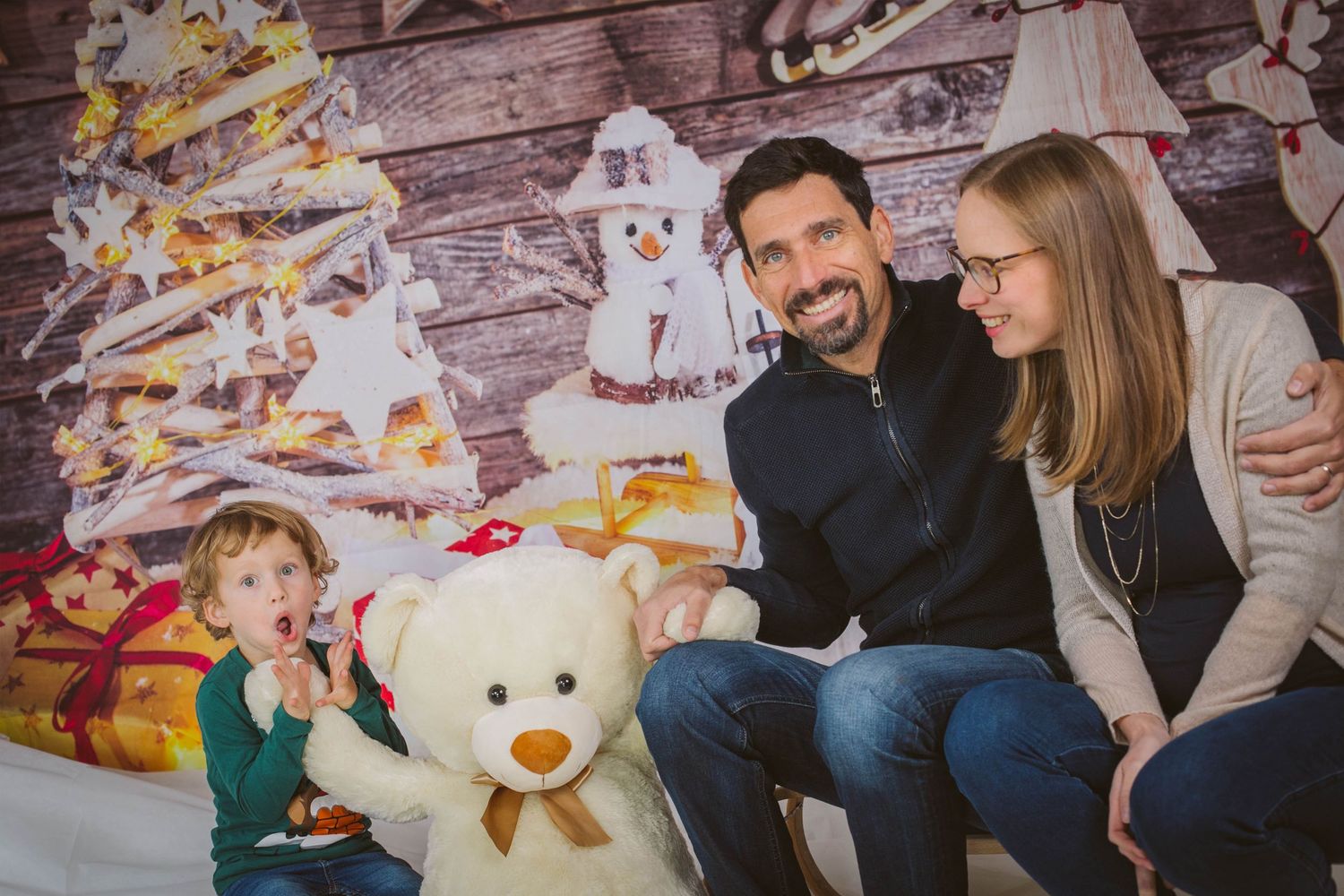 A series of romantic engagement photos with a couple and teddy bear props against a rustic wooden wall backdrop.