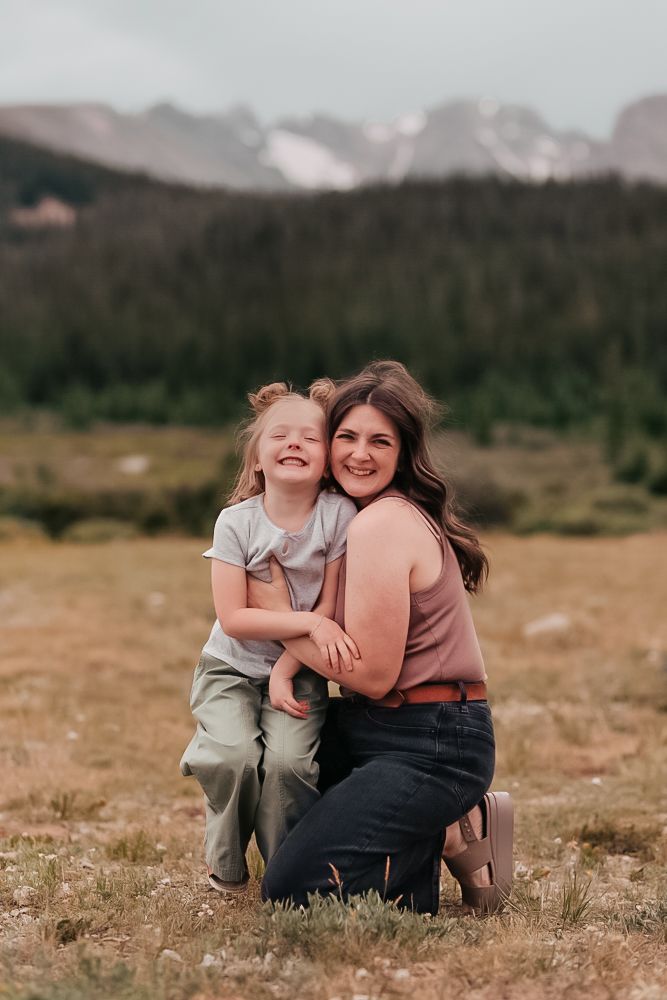 A series of heartwarming outdoor family portraits set against a mountainous backdrop with natural scenery.